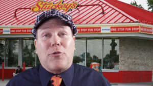 neil dandy in front of new stuckey's store