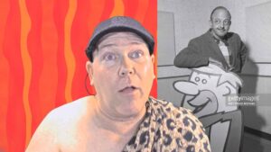 neil dandy with picture of mel blanc posing with cutout of barney rubble