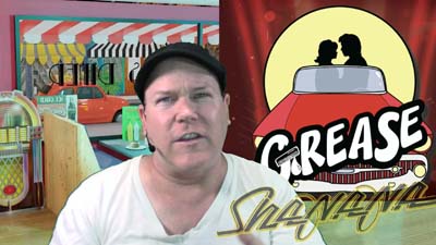 neil dandy with graphic for the musical play GREASE