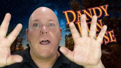 neil dandy in dark woods with dandy fun house logo and hands raised