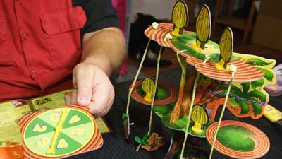 spinning the game spinner next to the monkey tree