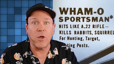 neil dandy with image of an advertisement for the first wham-o product, a slingshot