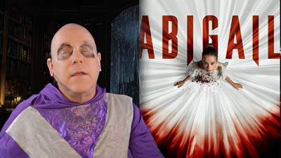 necro neil dandy next to promotional image for the movie abigail