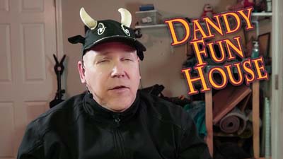 neil dandy in a cow hat with the dandy fun house logo