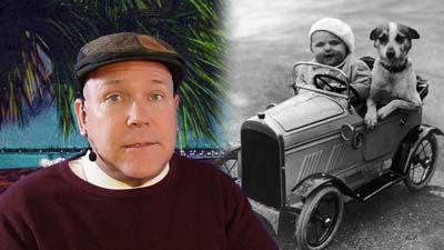 neil dandy with a picture of a young child with a dog inside a toy car
