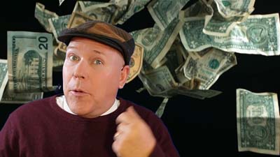 neil dandy with money falling from the sky behind him