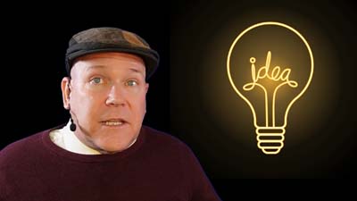 neil dandy with a graphic of the word "idea" inside a glowing light bulb