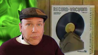 neil dandy with a picture of the ronco record vacuum