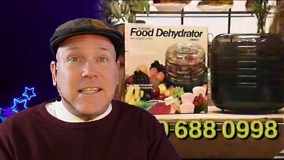 neil dandy with a picture of the ronco electric food dehydrator packaging