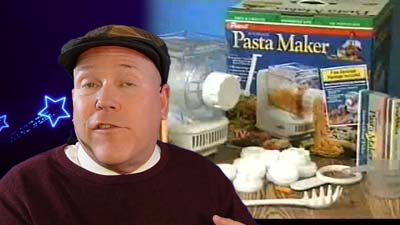 neil dandy with a picture of the ronco pasta maker packaging