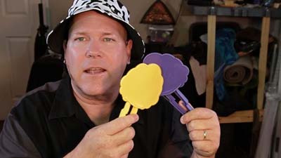 neil dandy holding the whack paddles for the game of cownado
