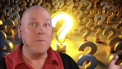 neil dandy with graphic depicting several question marks