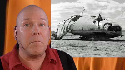 neil dandy with picture of wrecked airplane