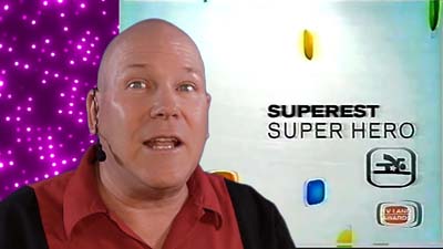 neil dandy with superest superhero logo