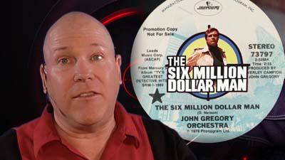 neil dandy with picture of six million dollar man theme song record